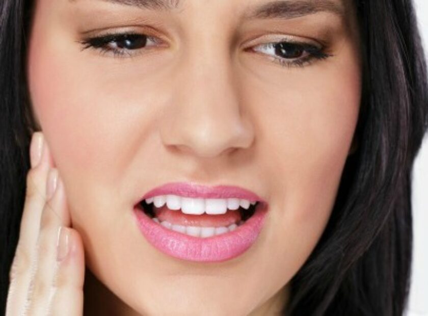 Young woman having tooth pain